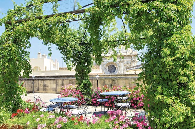 Patria Palace Puglia rooftop terrace outdoor dining area canopy of vines pink flowers