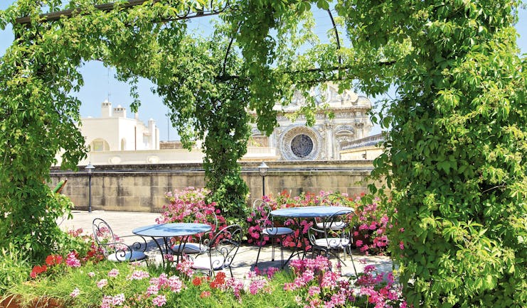 Patria Palace Puglia rooftop terrace outdoor dining area canopy of vines pink flowers