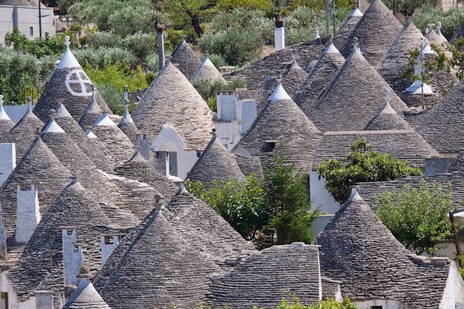 Conical grey slate roofs of the Trulli houses clustered together in Alberobello Puglia