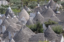 Conical grey slate roofs of the Trulli houses clustered together in Alberobello Puglia