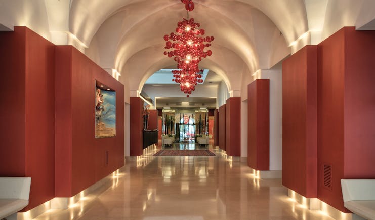 Risorgimento Resort Puglia lobby white tiles red walls contemporary décor