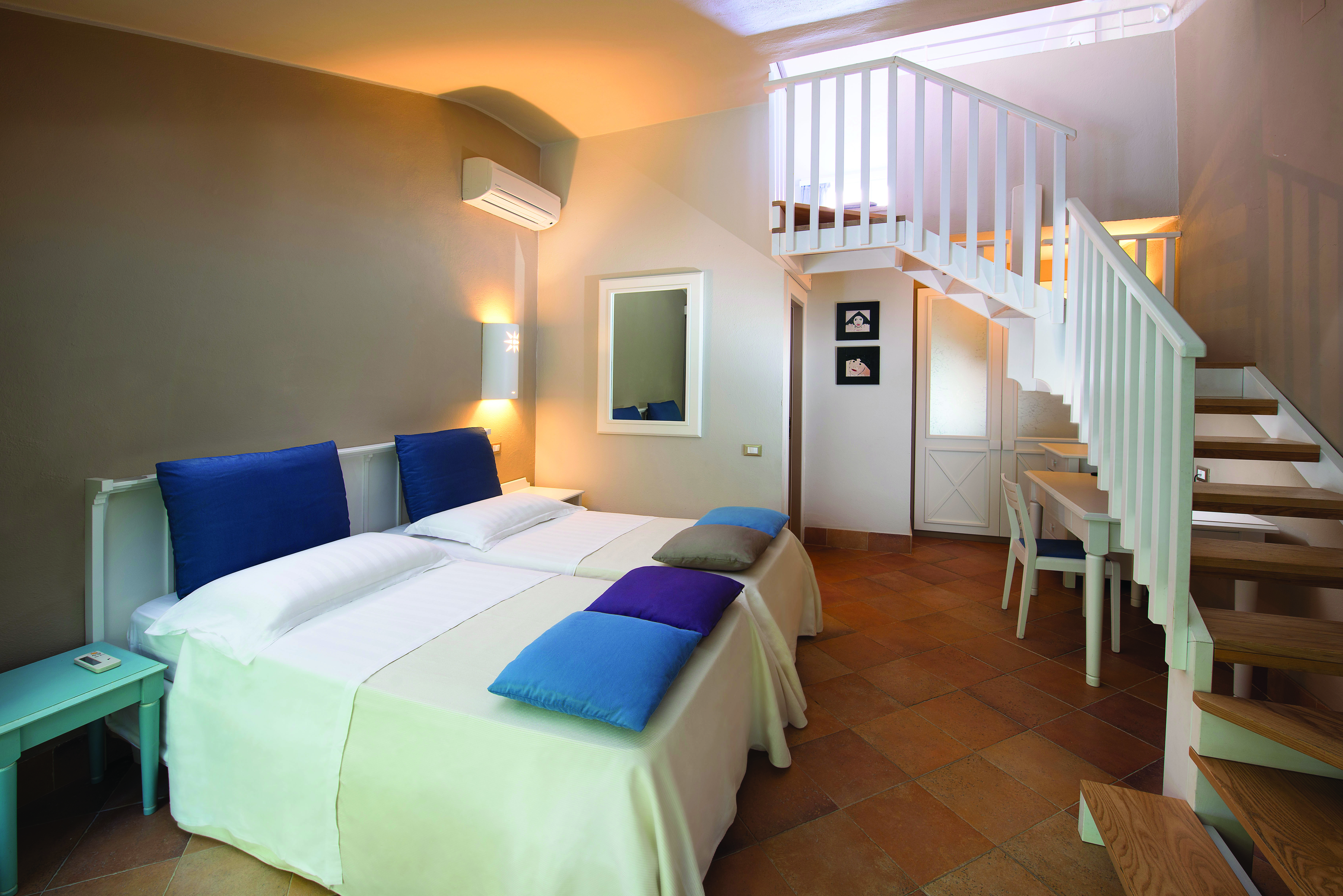 Bedroom in the family garden cottage with two floors and a white, purple and blue colour scheme