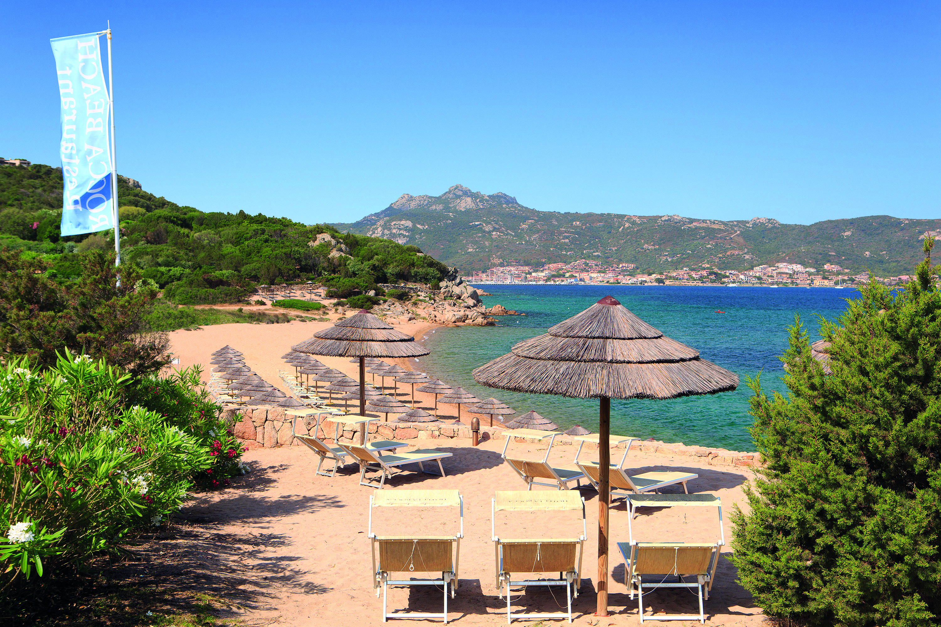 La Rocca Sardinia beach sun loungers umbrellas sandy beach