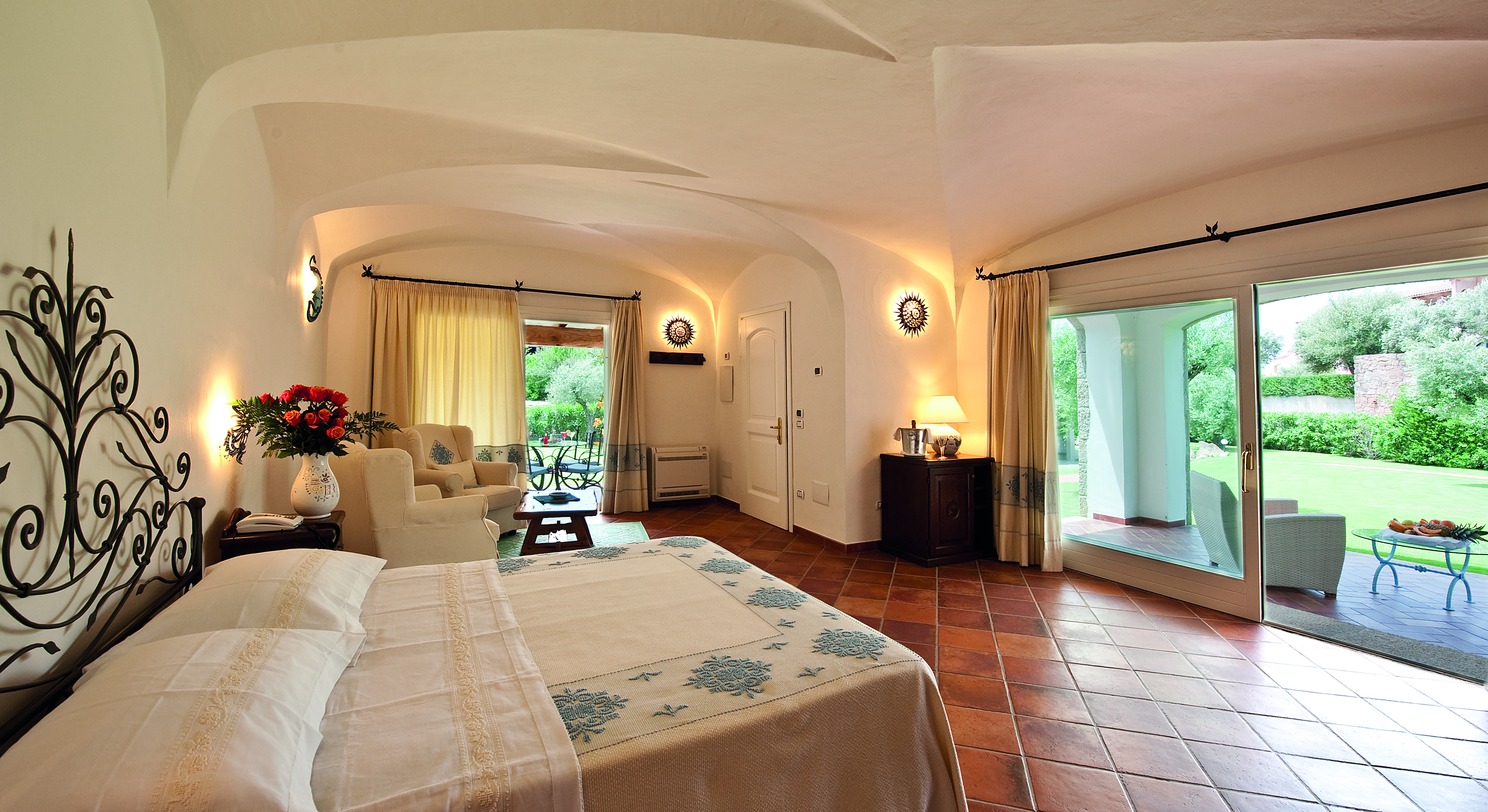 La Rocca Sardinia deluxe suite bedroom living area terrace overlooking garden modern décor