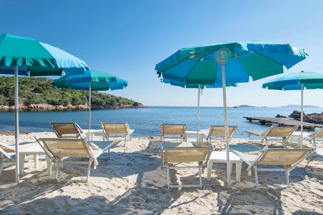 Hotel Le Ginestre Sardinia beach, white sand, sun loungers, umbrellas