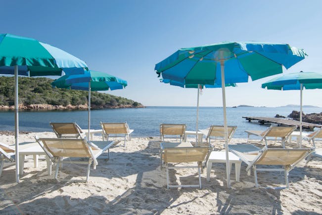 Hotel Le Ginestre Sardinia beach, white sand, sun loungers, umbrellas
