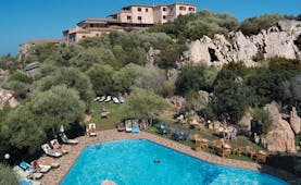Hotel Rocce Sarde Sardinia pool sun loungers gardens hotel building in background