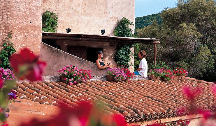 Hotel Rocce Sarde Sardinia terrace ladies chatting traditional rood tiles