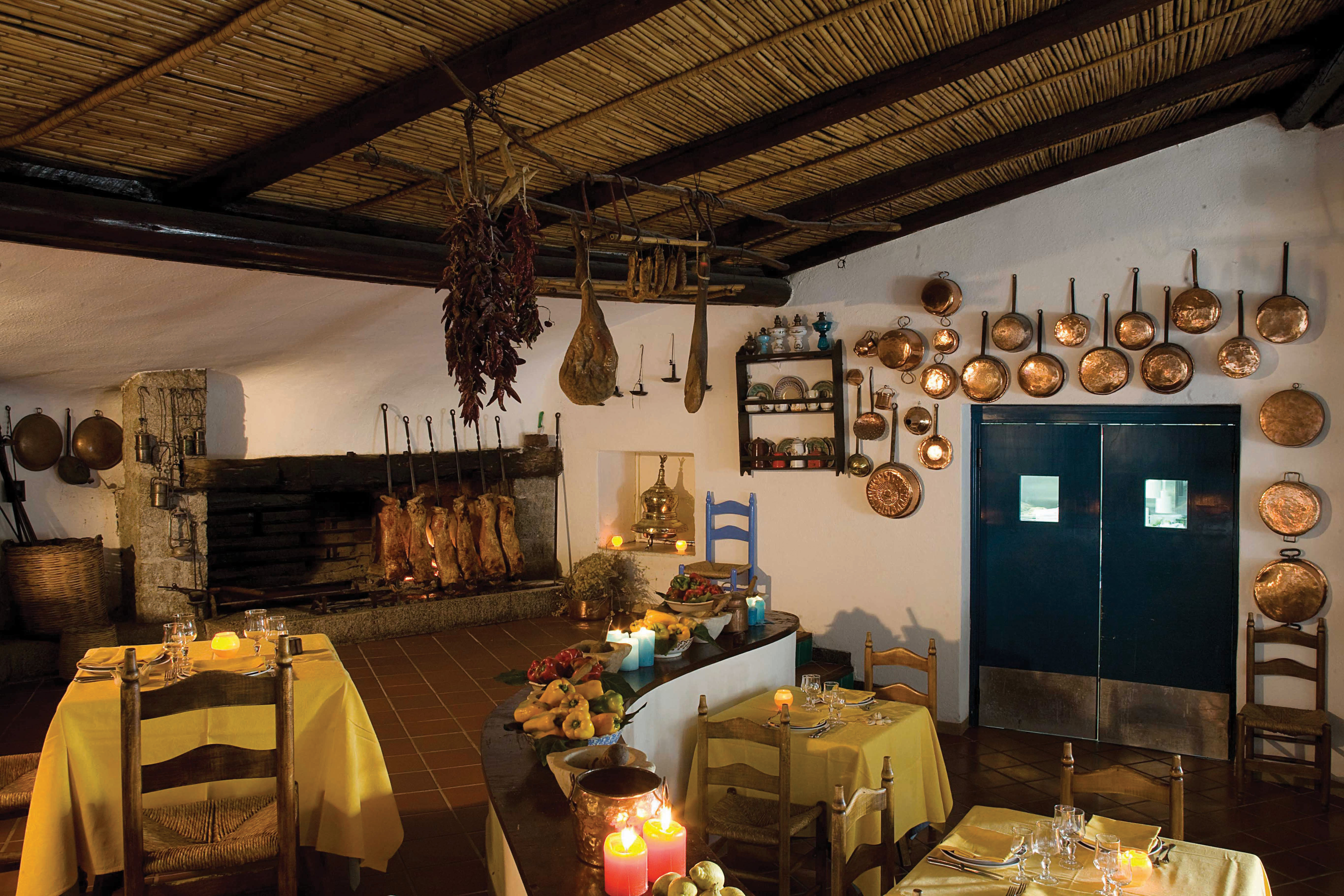 Restaurant with pots and pans for decoration, and tables set out for dinig 