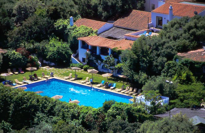 Swimming pool with sun loungers around the edge