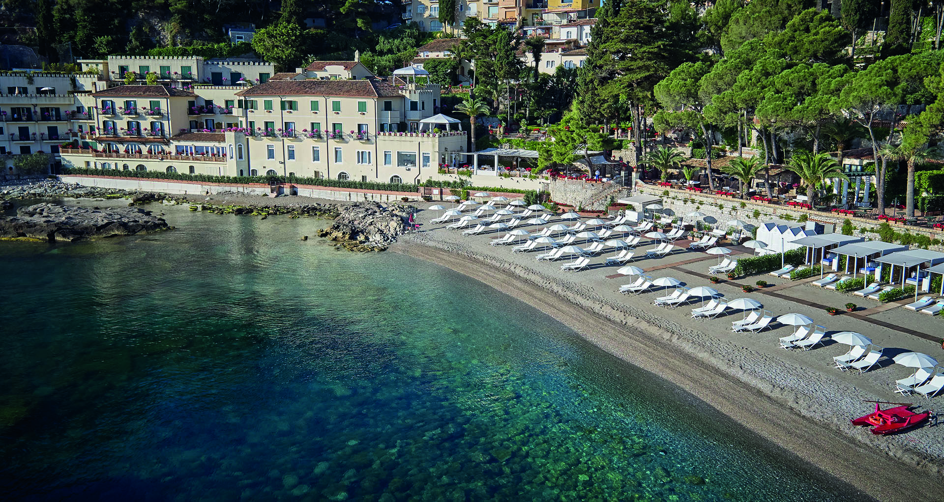 Villa Sant Andrea Sicily aerial shot of beach and  sun loungers umbrellas