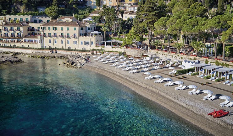Villa Sant Andrea Sicily aerial shot of beach and  sun loungers umbrellas