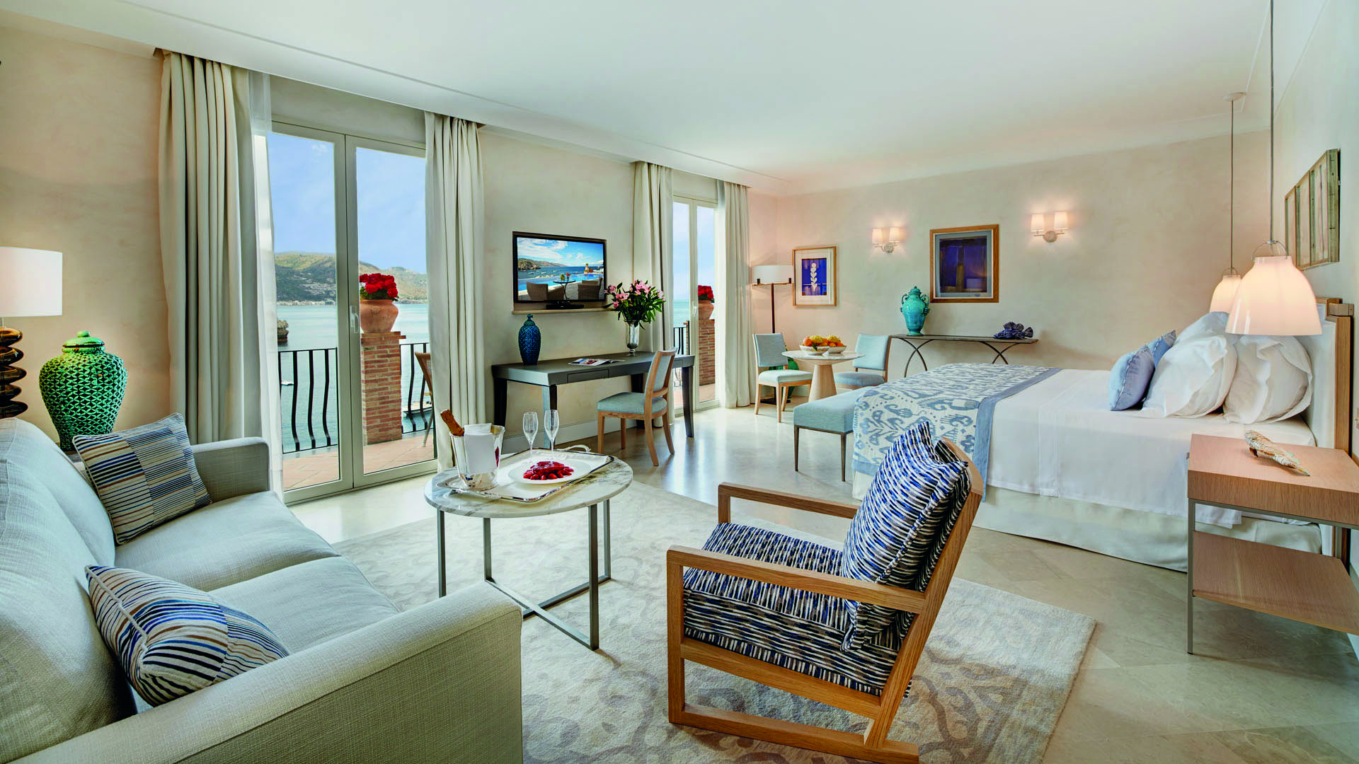 Villa Sant Andrea Sicily deluxe junior suite living area bed terrace overlooking sea modern décor