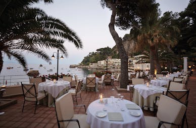 Villa Sant Andrea Sicily outdoor dining on the terrace overlooking the sea