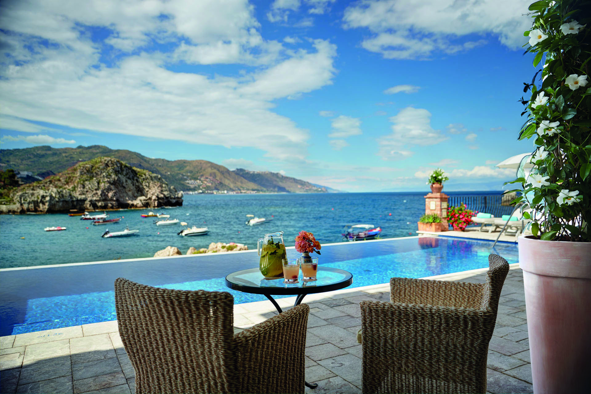 Villa Sant Andrea Sicily infinity pool and outdoor seating area overlooking sea