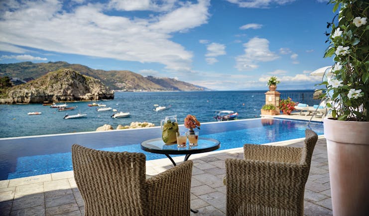 Villa Sant Andrea Sicily infinity pool and outdoor seating area overlooking sea