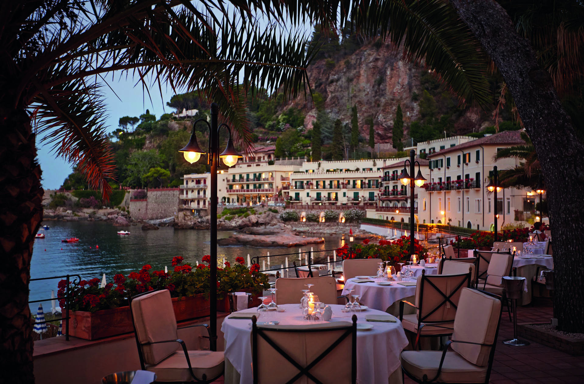 Villa Sant Andrea Sicily terrace outdoor dining terrace overlooking the sea candle light