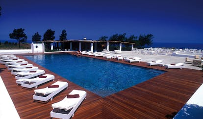 Capofaro Hotel Sicily pool terrace sun loungers sea in distance