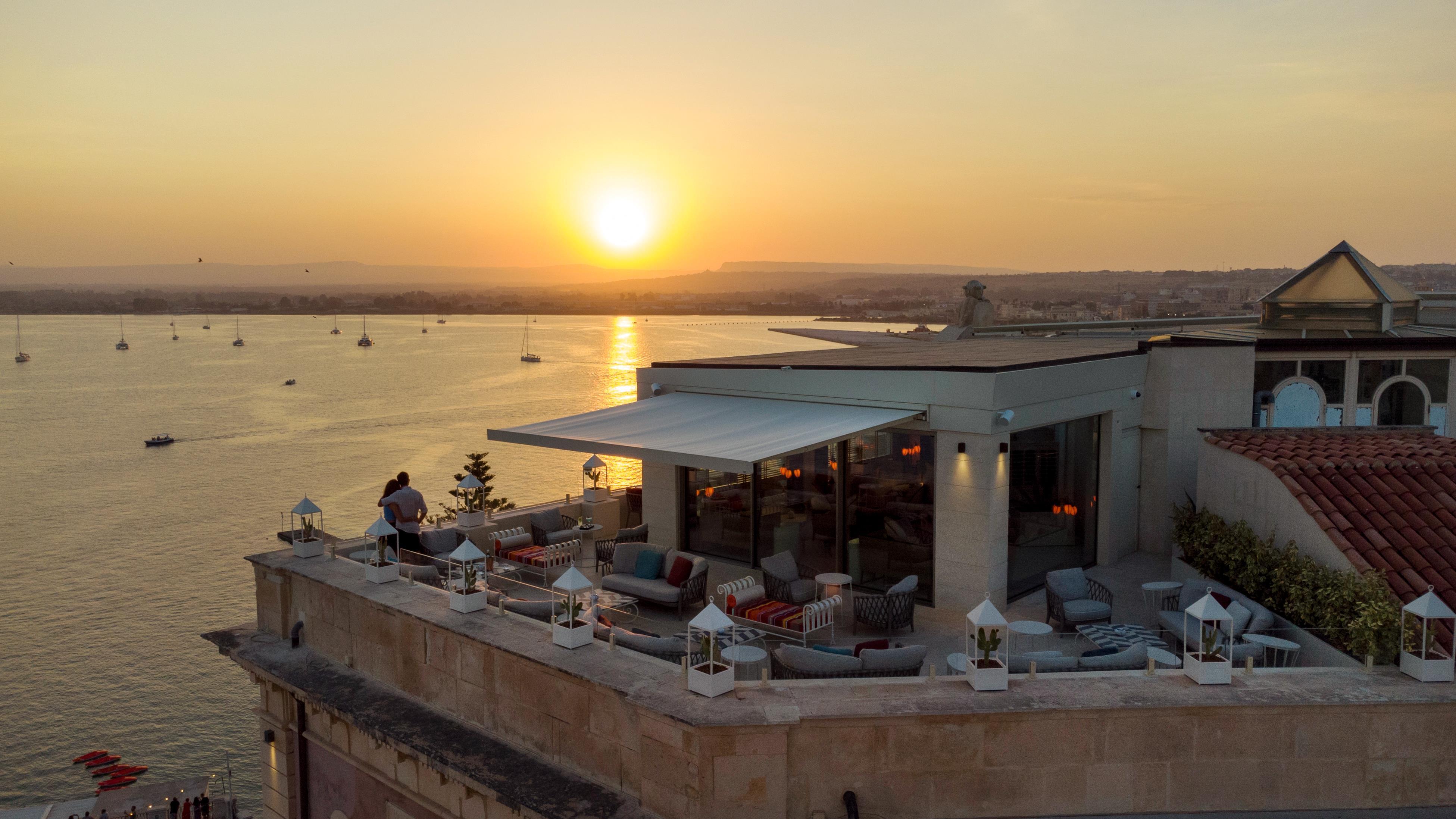 Grand hotel on waterfront in historic town of Ortigia