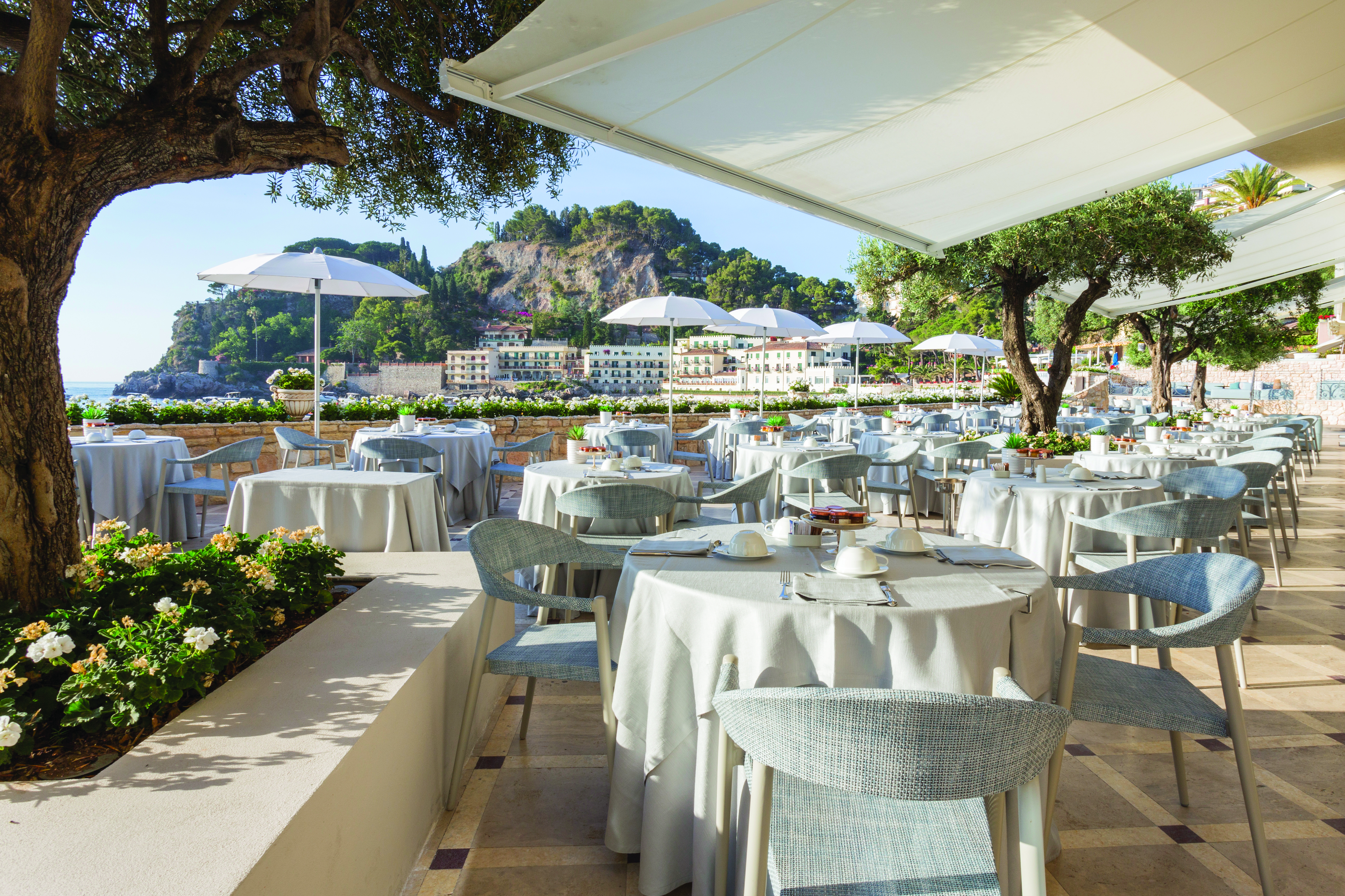 Mazzaro Sea Palace Sicily outdoor dining area tables chairs views  of the bay