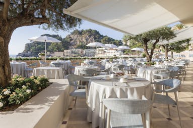 Mazzaro Sea Palace Sicily outdoor dining area tables chairs views  of the bay