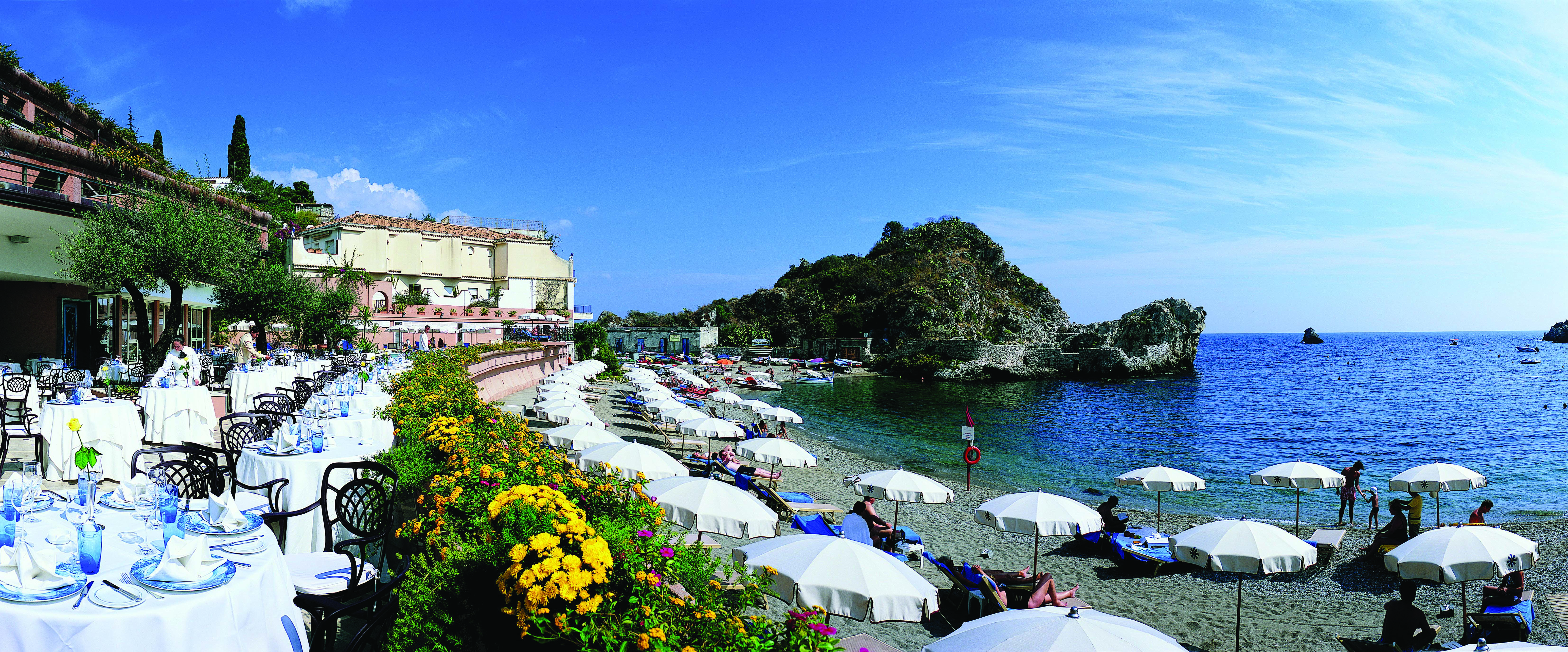 Mazzaro Sea Palace Sicily beach hotel in background out door dining area