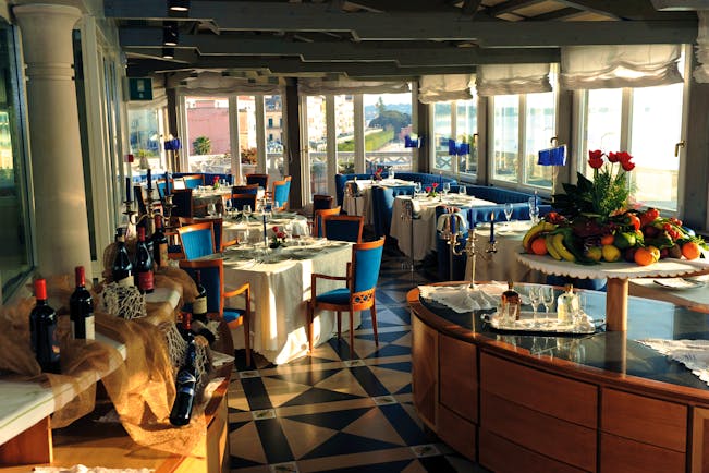 Restaurant with dining tables set out around the room and a fresh fruit platter