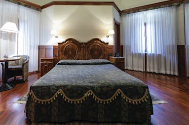Hotel Baglio Della Luna Sicily deluxe room bed television traditional décor