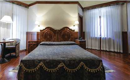 Hotel Baglio Della Luna Sicily deluxe room bed television traditional décor