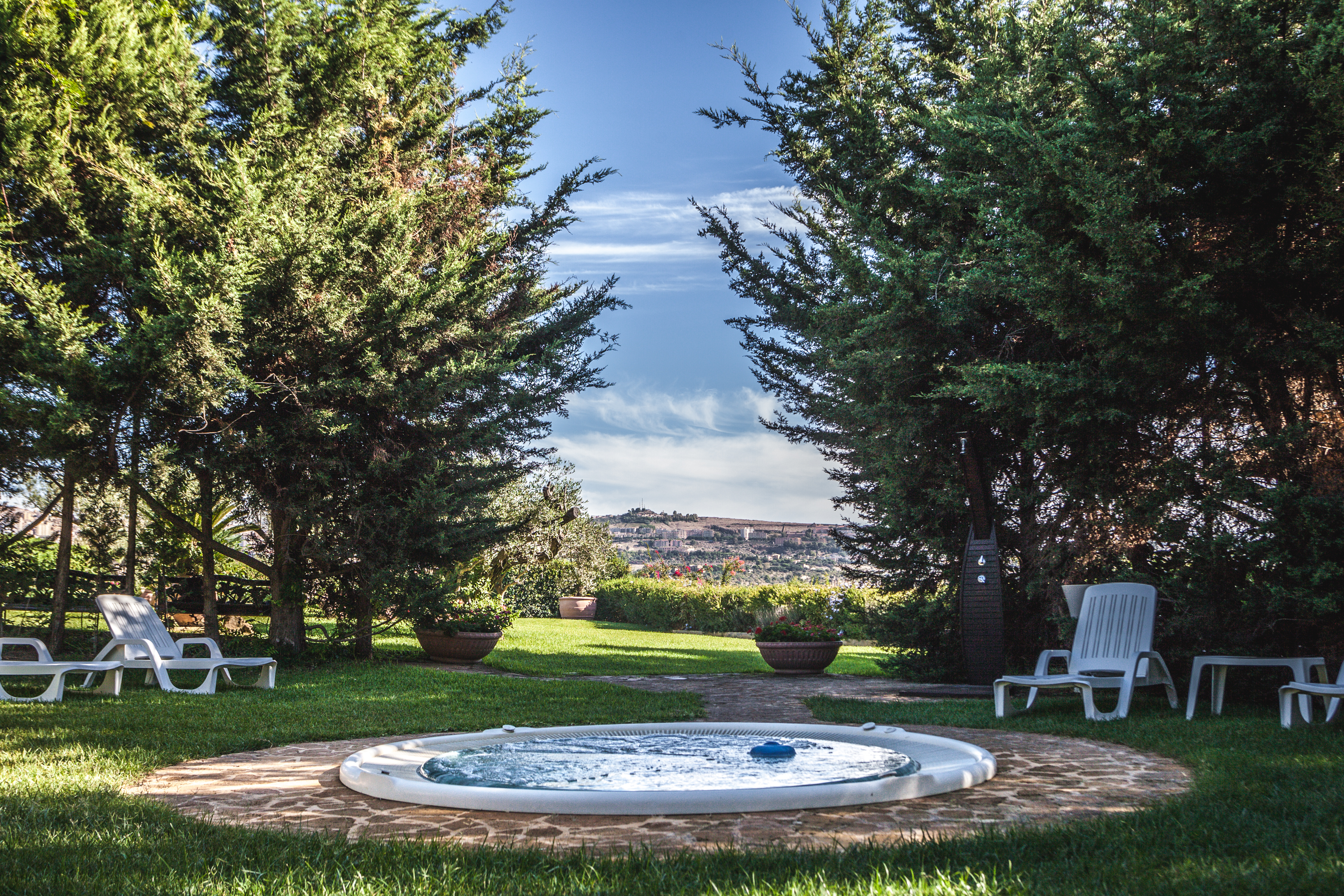 Hotel Baglio Della Luna Sicily outdoor jacuzzi lawns trees views of town