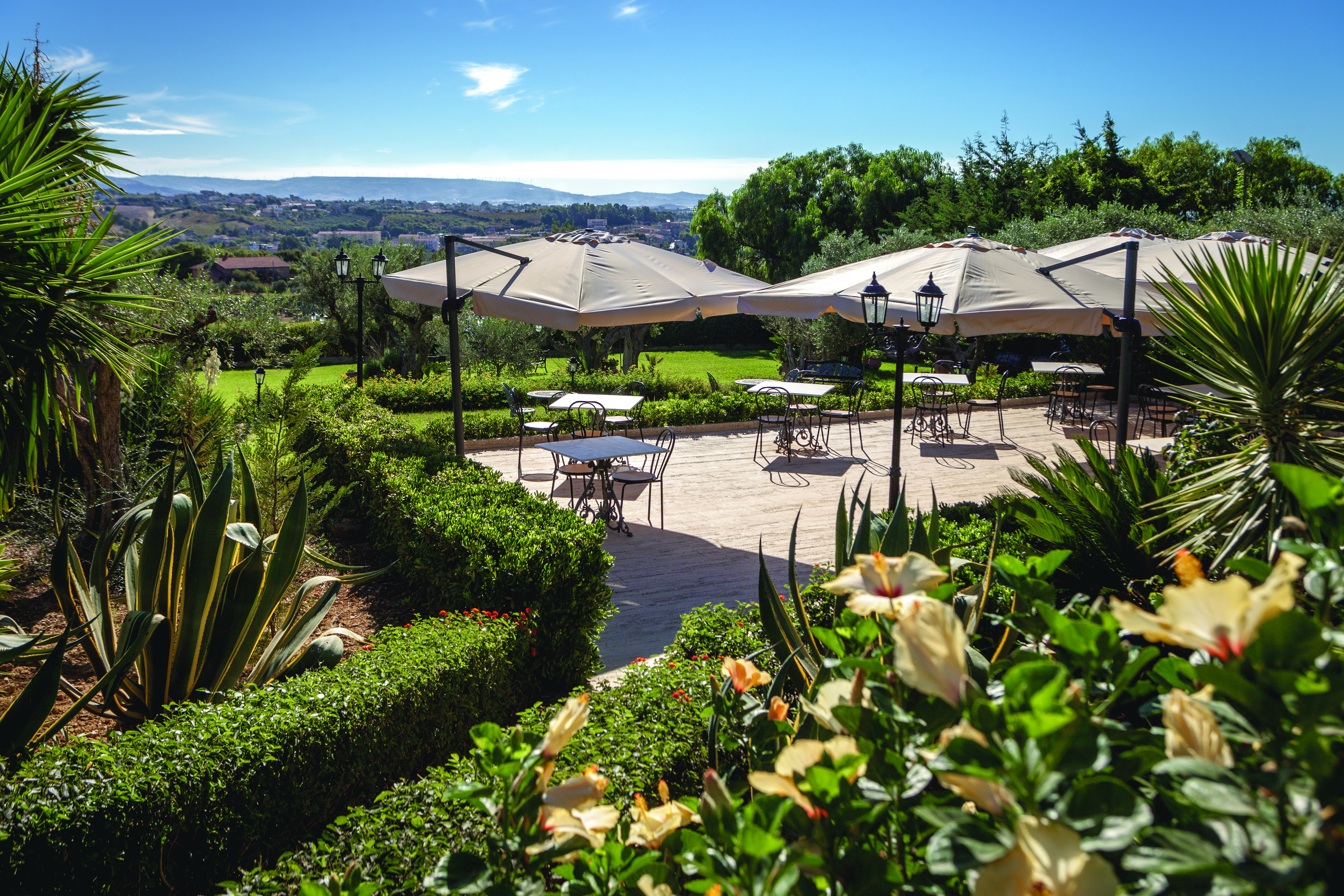 Hotel Baglio Della Luna Sicily terrace restaurant outdoor dining area overlooking the town