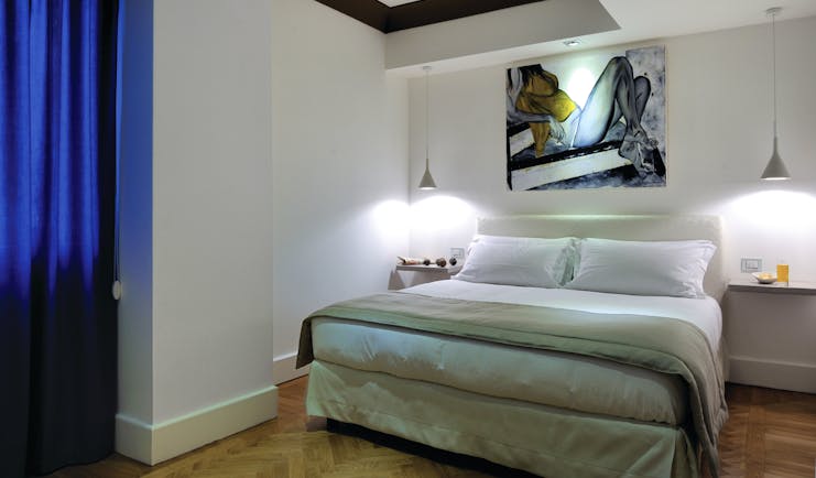 Hotel Principe di Villafranca superior room, double bed, white walls, wooden floors, modern decor