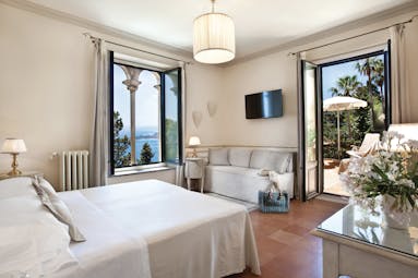 Hotel Villa Belvedere Sicily terrace suite bedroom sofa doors leading to terrace side view of ocean