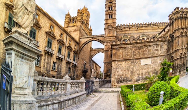 Intricate stonework of the Norman cathedral in Palermo with arches and towers