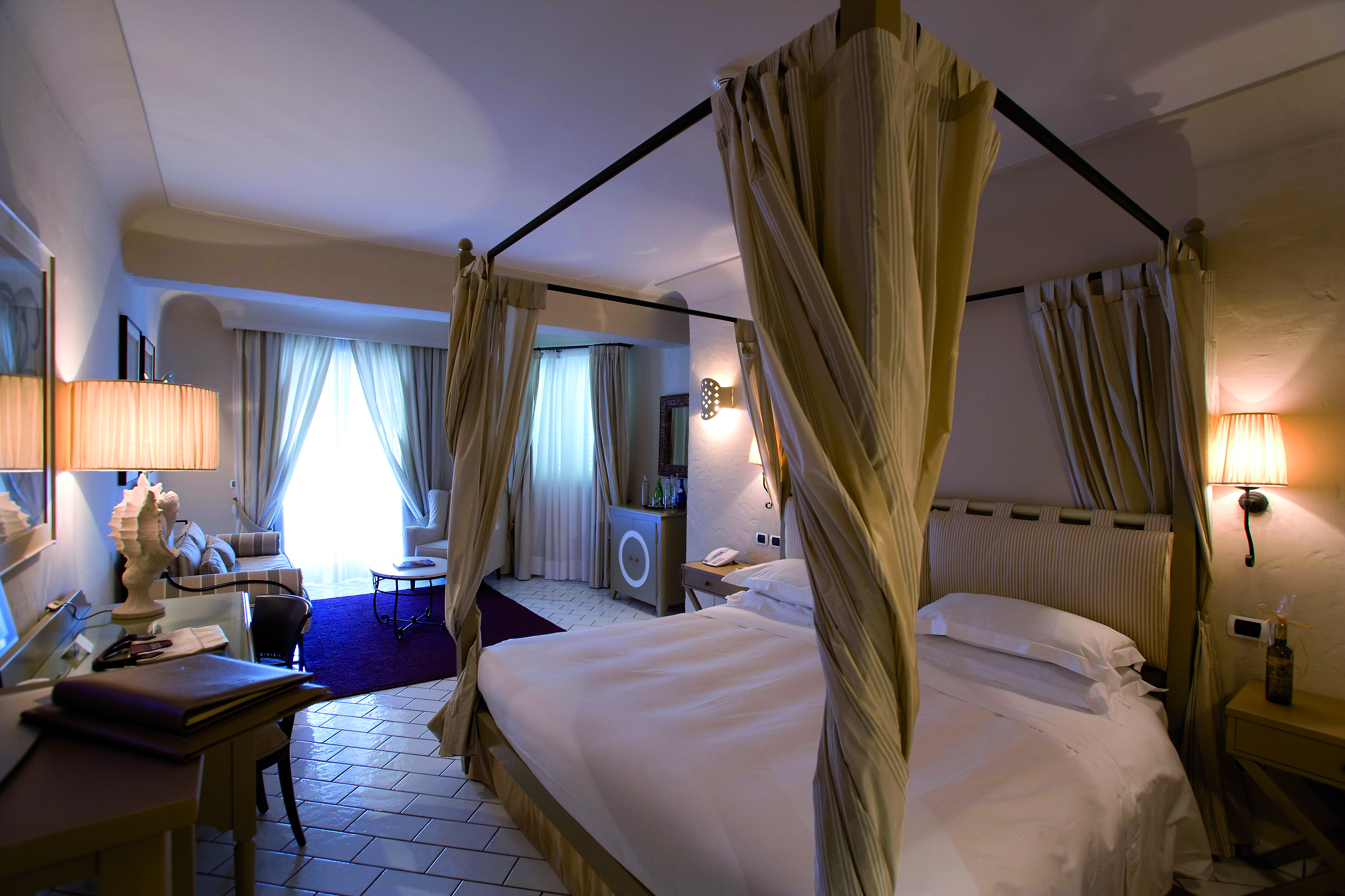Junior suite at the Therasia resort in Sicily with a cream and yellow colour scheme and large double bed