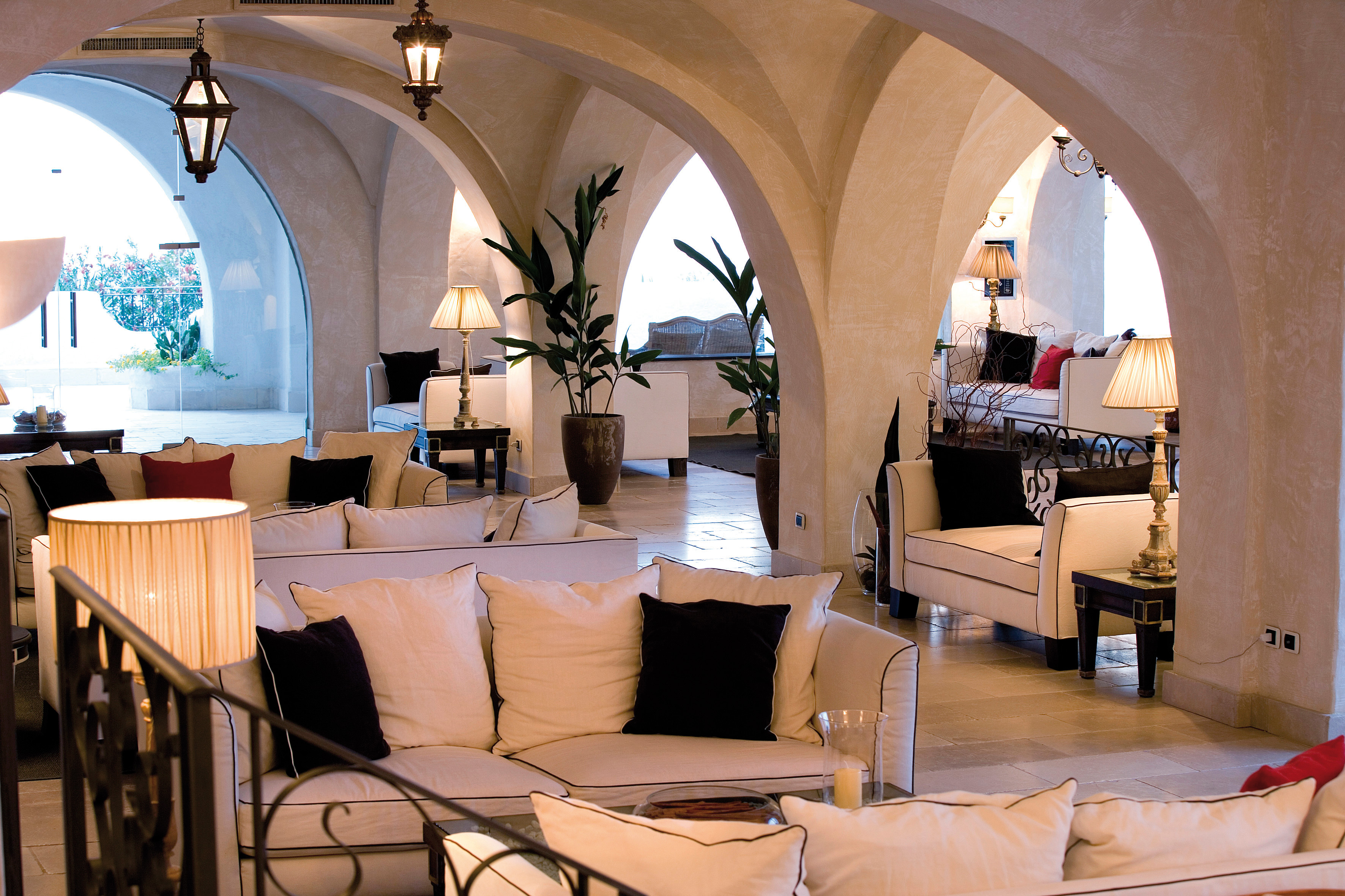 Hotel lovvy with sofas and potted plants around the room 