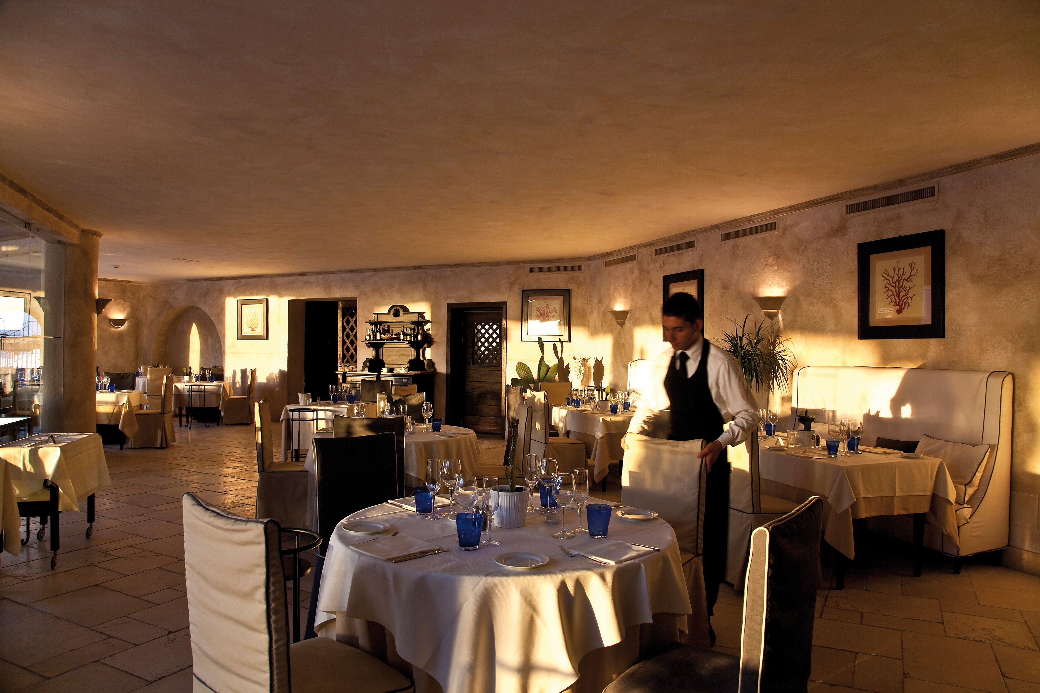 Restaurant with dining chairs and tables set up around a room 
