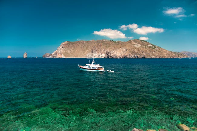 View of sea from hotel with boat and mountains in sea