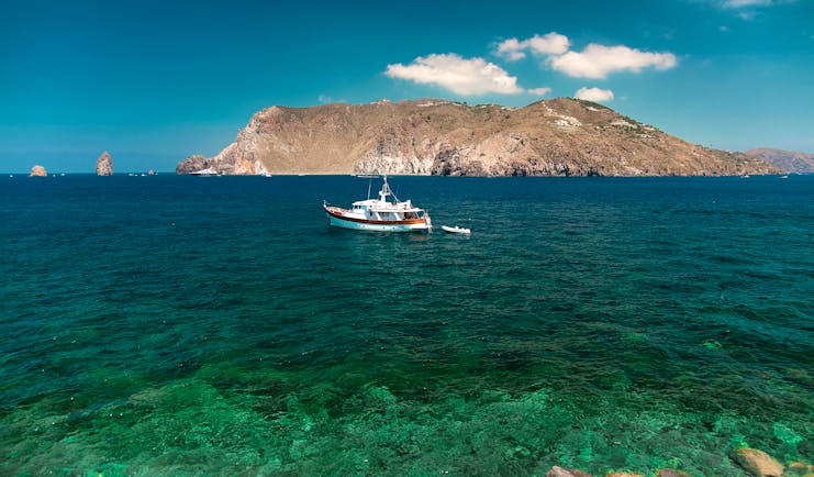 View of sea from hotel with boat and mountains in sea