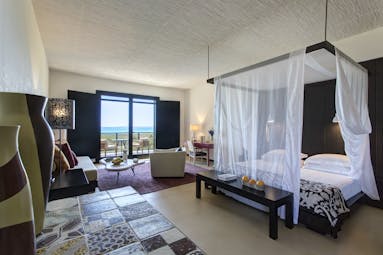 Verdura Resort four poster bed with sea view in distance