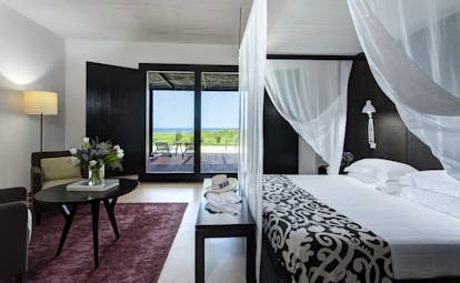Verdura Resort dark wood and white walls of villa suite peonia