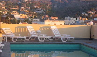 Villa Meligunis Sicily poolside sun loungers view of town