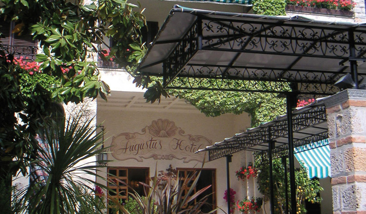Augustus Hotel Tuscany entrance doorway trees shrubs