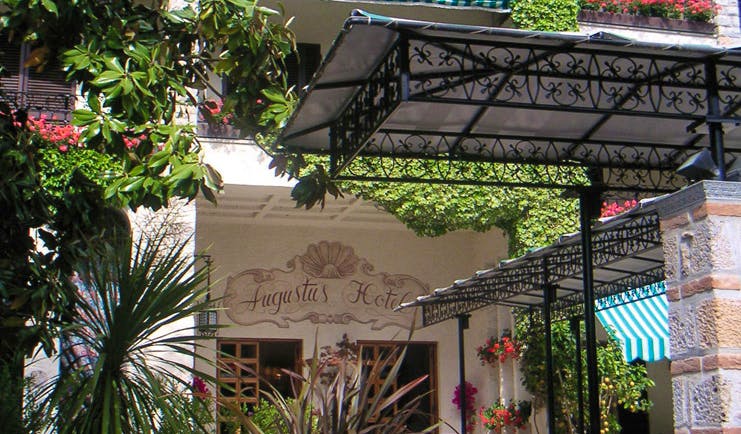 Augustus Hotel Tuscany entrance doorway trees shrubs