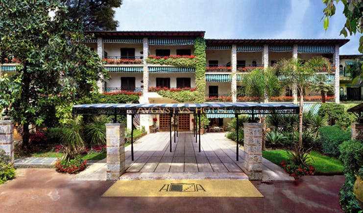 Augustus Hotel Tuscany exterior hotel entrance walkway hotel building lawns trees 