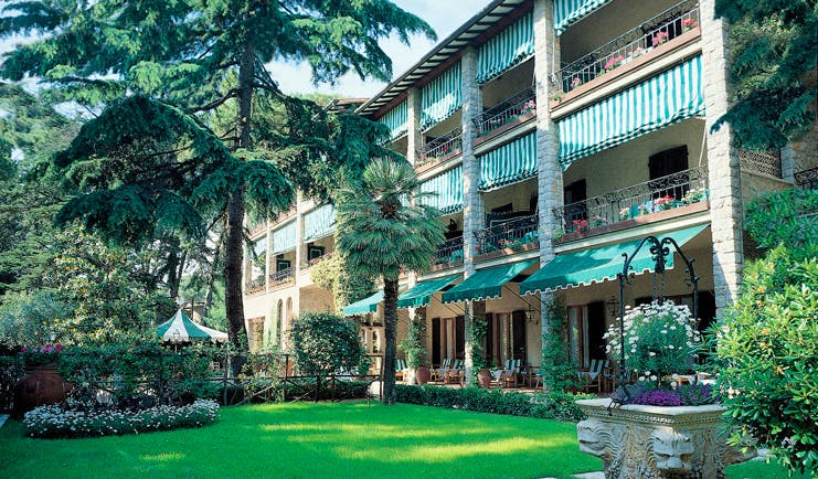 Augustus Hotel Tuscany grounds hotel building lawns trees potted plants