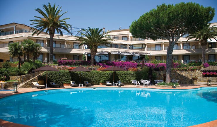 Cala del Porto Tuscany exterior hotel building pool sun loungers umbrellas