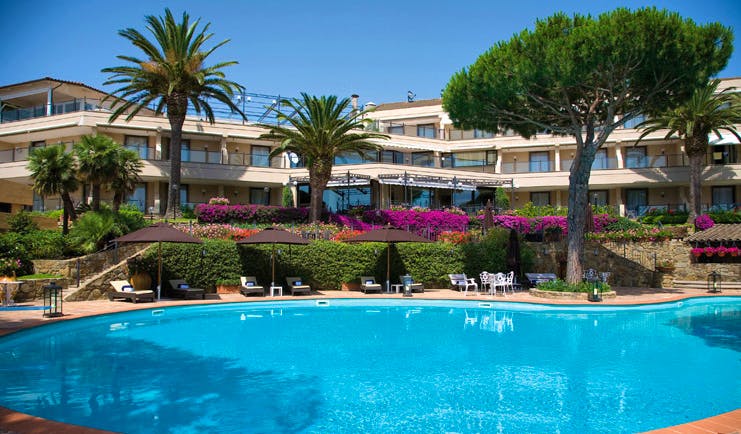 Cala del Porto Tuscany exterior hotel building pool sun loungers umbrellas