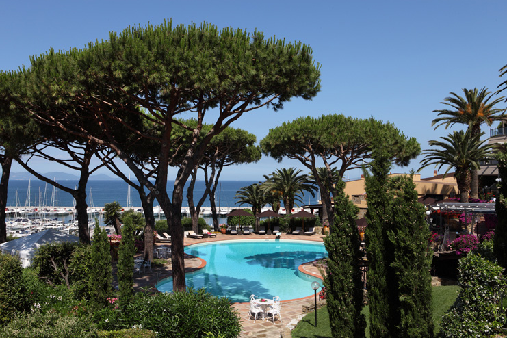 Cala del Porto Tuscany pool terrace sun loungers umbrellas harbour in background