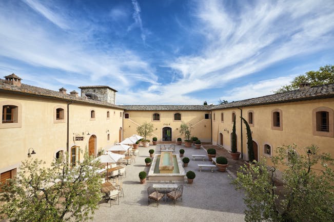 Belmond Castello di Casole Tuscany courtyard daytime outdoor seating water feature